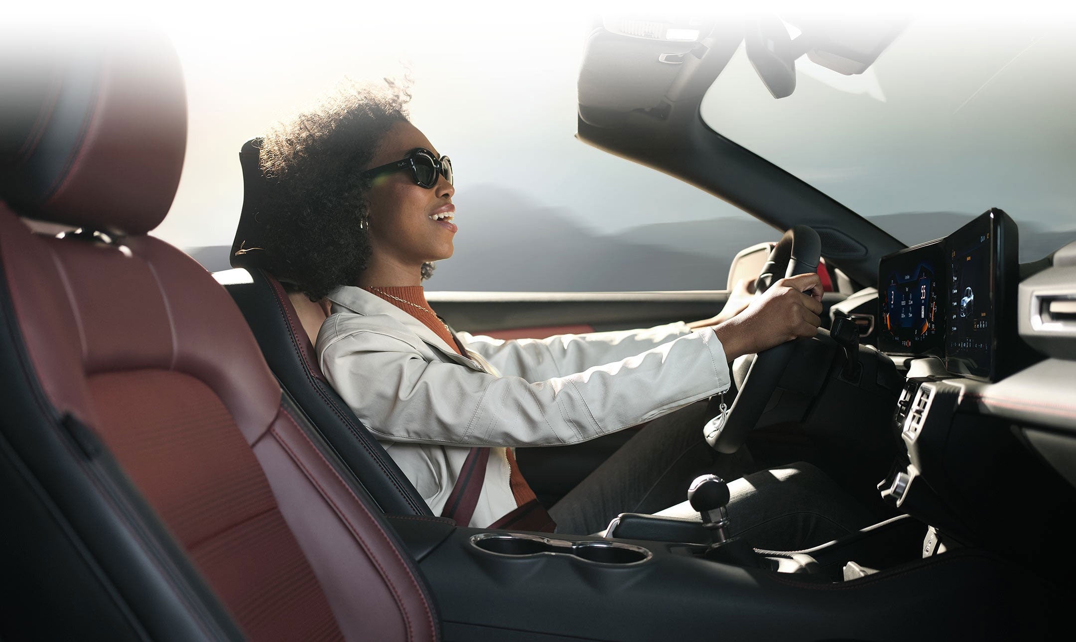 Person sitting in the driver’s seat of a 2024 Ford Mustang® convertible | Lombard Ford in Winsted CT